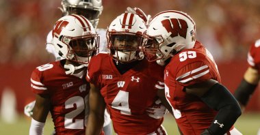 Wisconsin Badgers cornerback Donte Burton (4) celebrates with cornerback Semar Melvin (20) and linebacker Maema Njongmeta (55) following an interception during the fourth quarter against the Eastern Michigan Eagles at Camp Randall Stadium, Madison, Wisconsin, U.S., Sept. 11, 2021. (Jeff Hanisch-USA TODAY Sports via REUTERS)