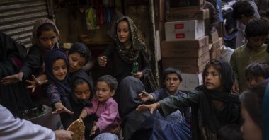 Afghan women and children receive bread donations in Kabul's Old City, Afghanistan, Sept. 16, 2021. (AP Photo)