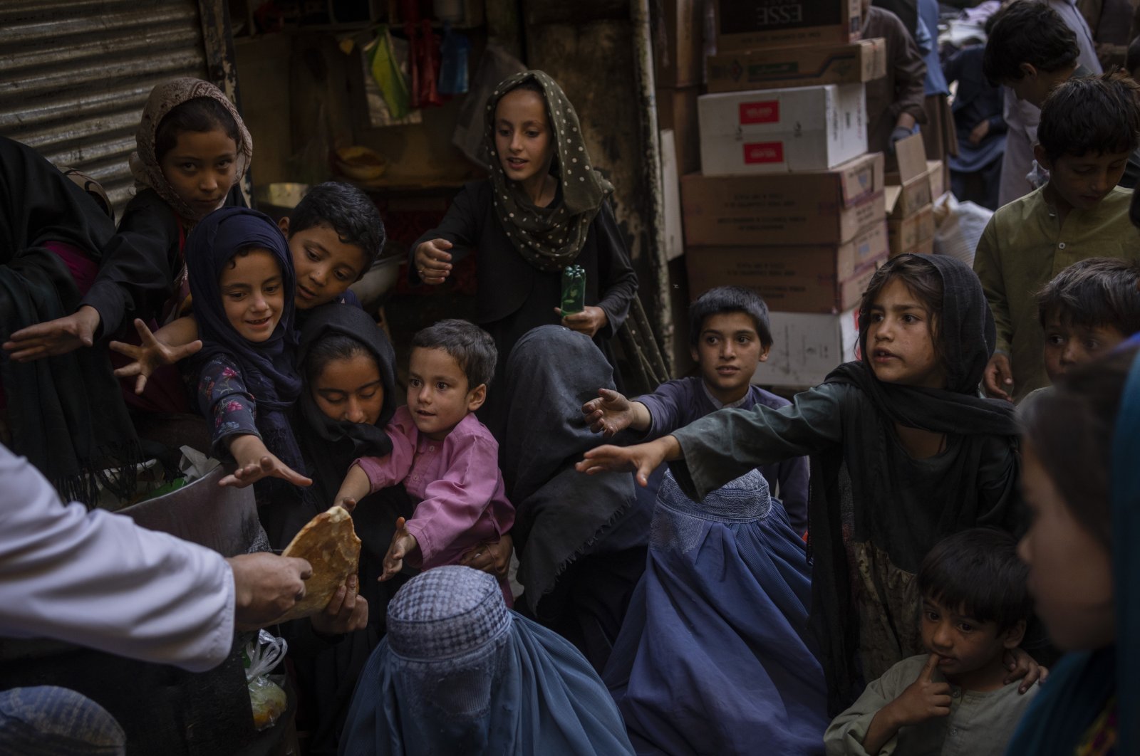 Afghan women and children receive bread donations in Kabul's Old City, Afghanistan, Sept. 16, 2021. (AP Photo)