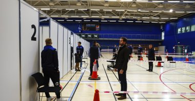 People line-up to vote outside a polling station in Gardabae, Iceland, Sept. 25, 2021. (AP Photo)