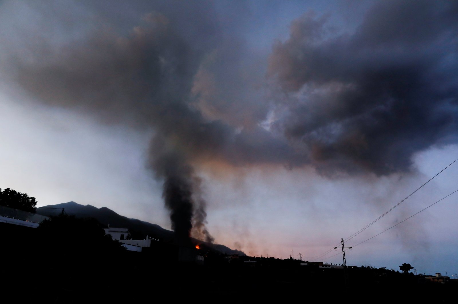 Lava and smoke rise at dawn following the eruption of a volcano on the Canary Island of La Palma, in El Paso, Spain, Sept. 25, 2021. (Reuters Photo)
