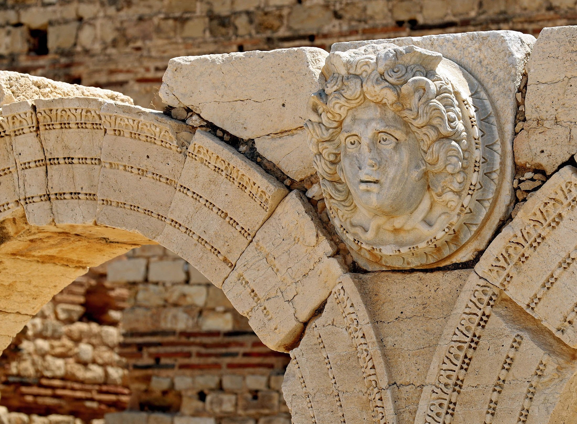 A carved Gorgon head on arches surrounding the Severin forum, in the ancient Roman city of Leptis Magna near the coastal city of al-Khums, Libya, Aug. 24, 2021. (AFP Photo)