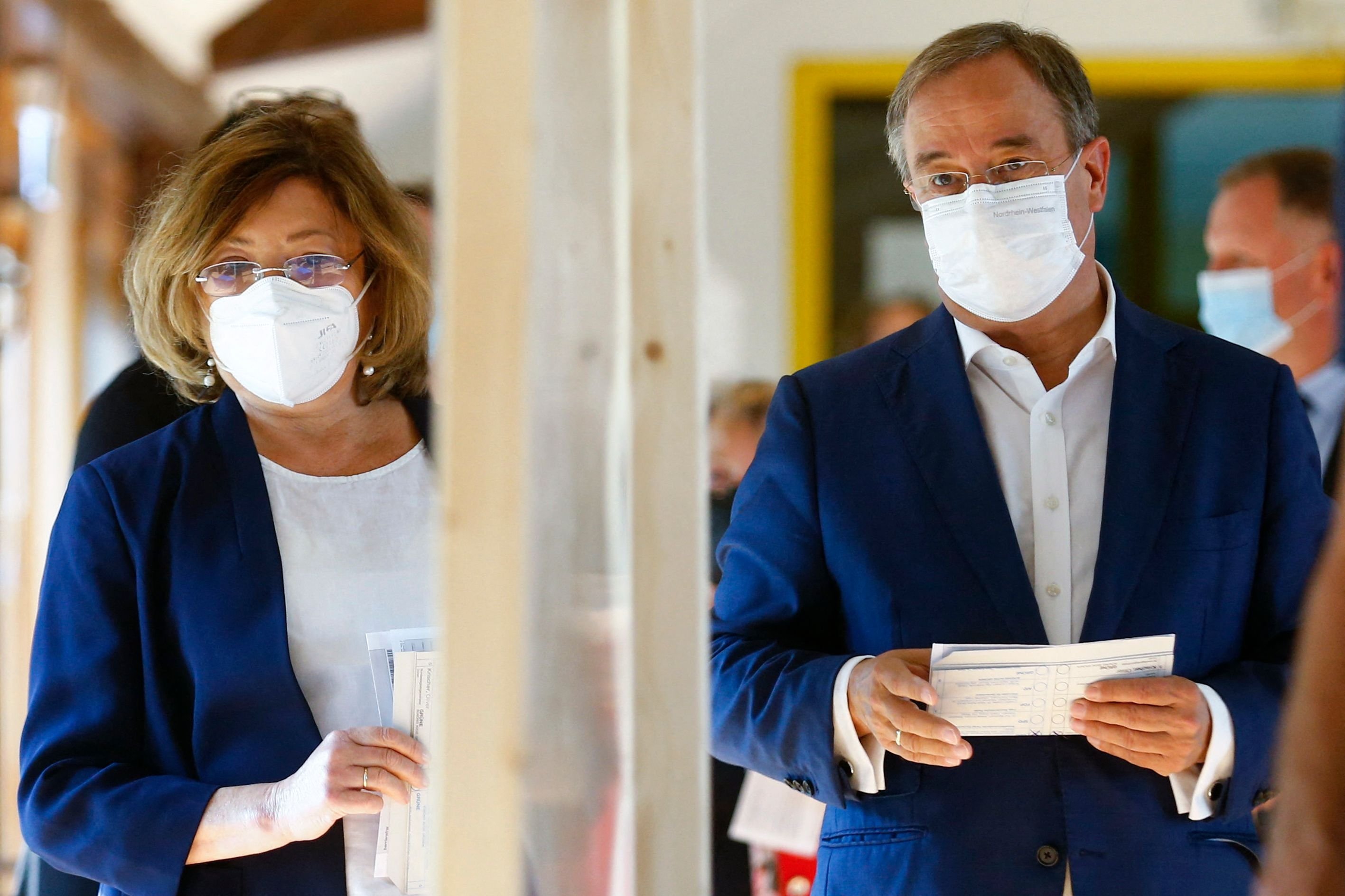 Germany's conservative Christian Democratic Union CDU leader and candidate for chancellor Armin Laschet and his wife Susanne Laschet arrive to cast their ballots at a polling station in Aachen, western Germany, during general elections on September 26, 2021. (AFP Photo)
