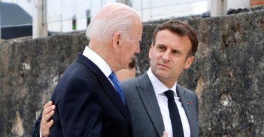 U.S. President Joe Biden (L) and French President Emmanuel Macron speak after the family photo at the start of the G-7 summit in Carbis Bay, Cornwall, Britain, June 11, 2021. (AFP Photo)