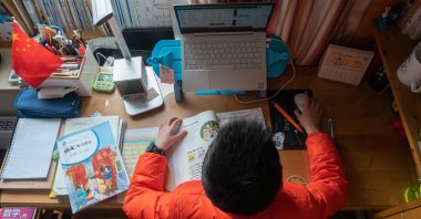 A primary school student takes classes online, studying from home, Shanghai, China, March 3, 2020. (Reuters Photo)