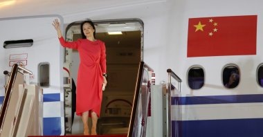 Huawei CFO Meng Wanzhou waves as she steps out of a charter plane at Shenzhen Baoan International Airport in Shenzhen, Guangdong Province, China, Sept. 25, 2021. (Reuters Photo)