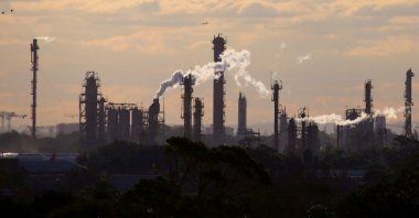 Birds and a plane are seen flying above emission from the chimneys of a chemical plant located near Port Botany in Sydney, Australia, June 2, 2017. (Reuters Photo)