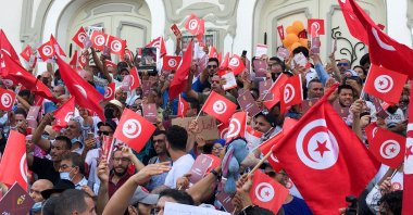 Demonstrators carry flags during a protest against Tunisian President Kais Saied's seizure of governing powers, in Tunis, Tunisia, September 26, 2021. (Reuters Photo)