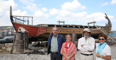 Members of the group pose in front of Kybele, a replica of an ancient boat they constructed, in Izmir, western Turkey, Sept. 25, 2021. (AA PHOTO)