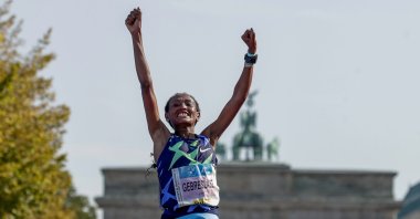 Ethiopia's Gotytom Gebreslase celebrates as she crosses the finish line to win the women's division of the Berlin Marathon in Berlin, Germany, Sept. 26, 2021. (AP Photo)