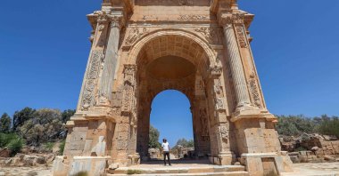 A man looks at the Arch of Septimus Severus in the ancient Roman city of Leptis Magna near the coastal city of al-Khums, Libya, Aug. 24, 2021. (AFP Photo)