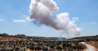 A smoke plume rises after an aerial bombardment near a make-shift camp for displaced Syrians near the town of Kafraya, north of Syria's Idlib province, Syria, Sept. 7, 2021. (AFP Photo)