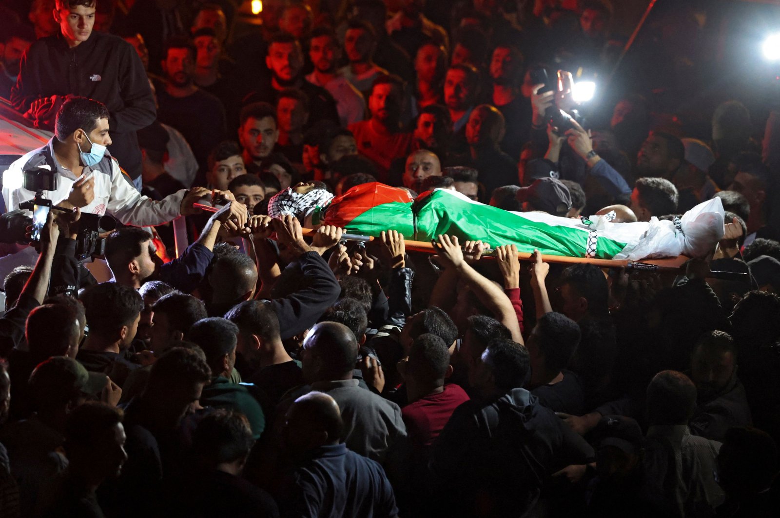 Mourners carry the body of Mohammed Khabisa, a Palestinian who was shot dead by Israeli troops, during his funeral in the village of Beita, the occupied West Bank, Palestine, Sept. 24, 2021. (AFP Photo)