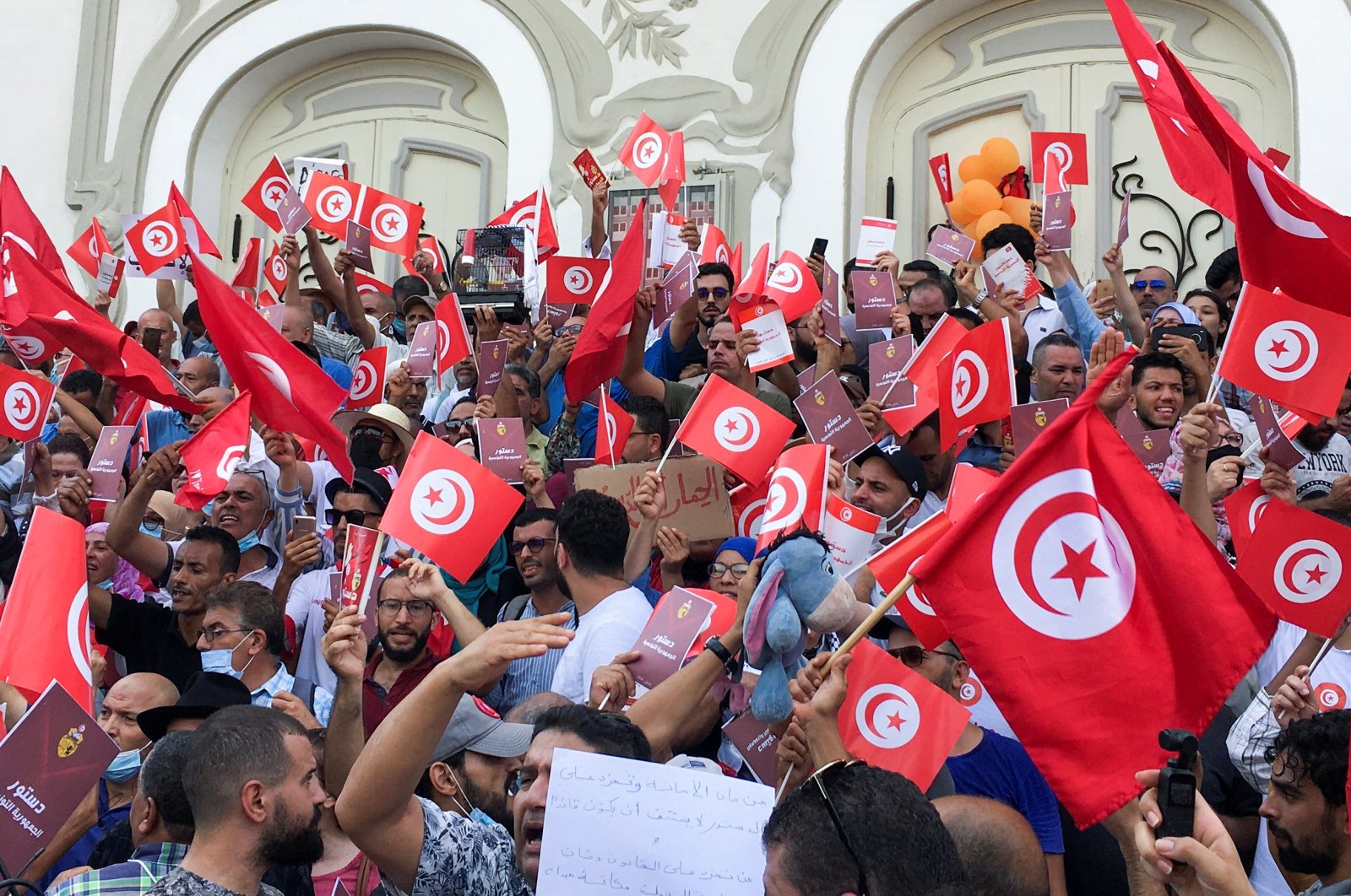 Demonstrators carry flags during a protest against Tunisian President Kais Saied's seizure of governing powers, in Tunis, Tunisia, September 26, 2021. (Reuters Photo)