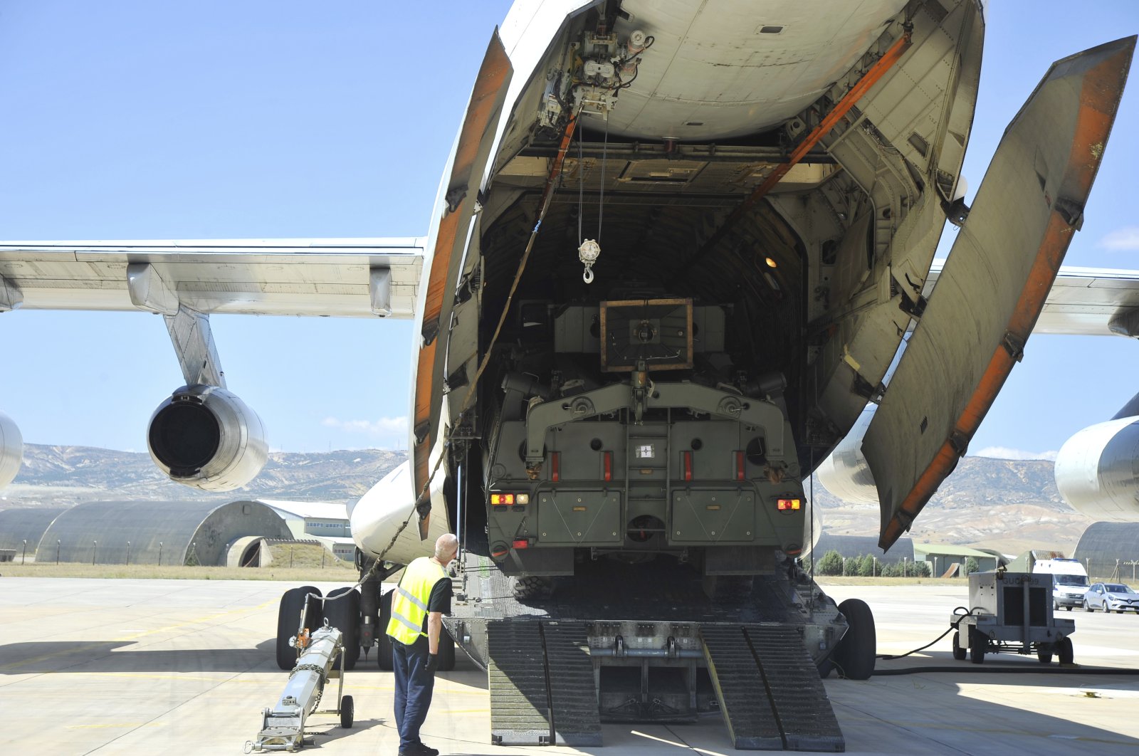 Military officials work around a Russian transport aircraft, carrying parts of the S-400 air defense systems, after it landed at Mürted military airport outside Ankara, Turkey, Aug. 27, 2019. (AP Photo)