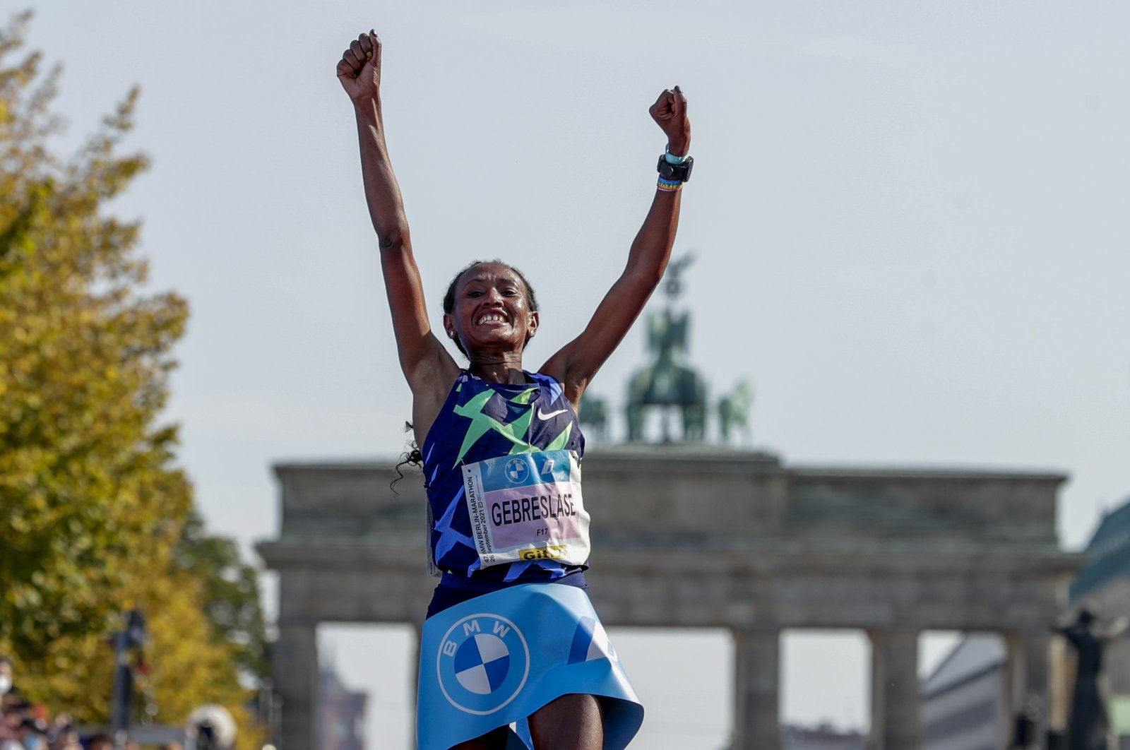 Ethiopia's Gotytom Gebreslase celebrates as she crosses the finish line to win the women's division of the Berlin Marathon in Berlin, Germany, Sept. 26, 2021. (AP Photo)