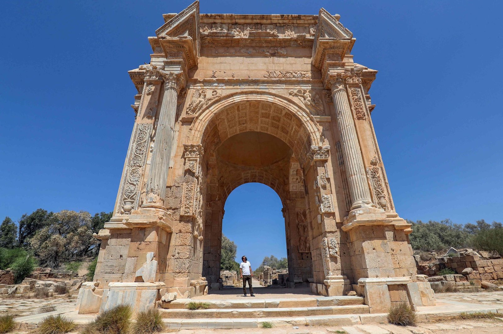 A man looks at the Arch of Septimus Severus in the ancient Roman city of Leptis Magna near the coastal city of al-Khums, Libya, Aug. 24, 2021. (AFP Photo)