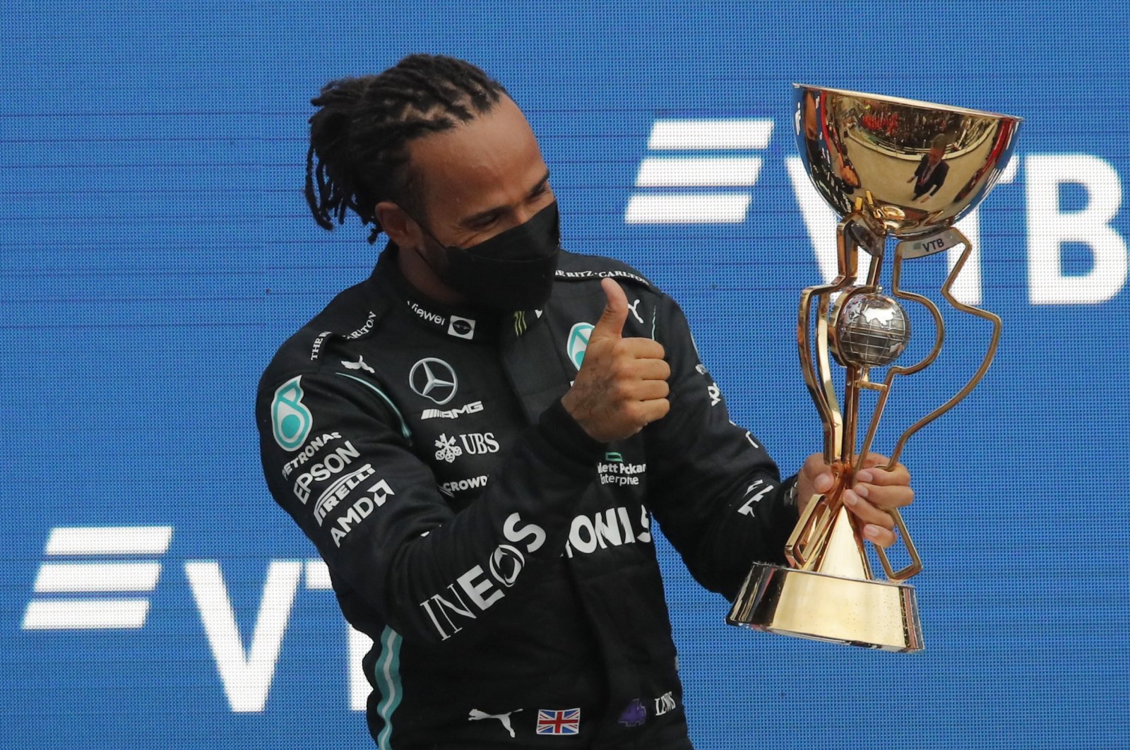 Mercedes' Lewis Hamilton celebrates with the Russian Grand Prix trophy after winning the race at Sochi, Russia, Sept. 26, 2021. (Reuters Photo)