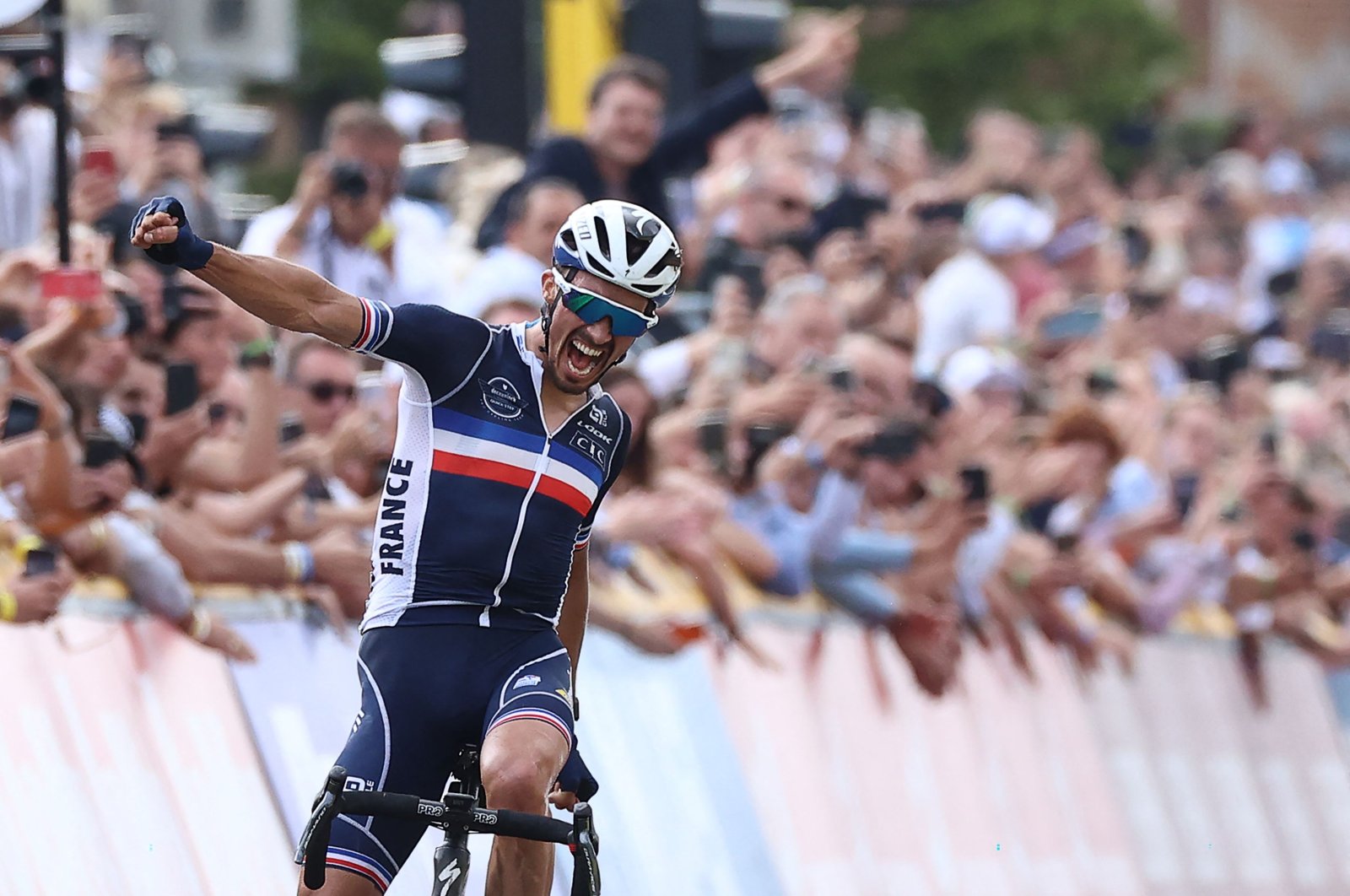 France's Julian Alaphilippe celebrates winning the men's cycling road race, 268.3 kilometers from Antwerp to Leuvenduring the 2021 Road World Championships, Sept. 26, 2021, in Leuven, Belgium. (AFP Photo)