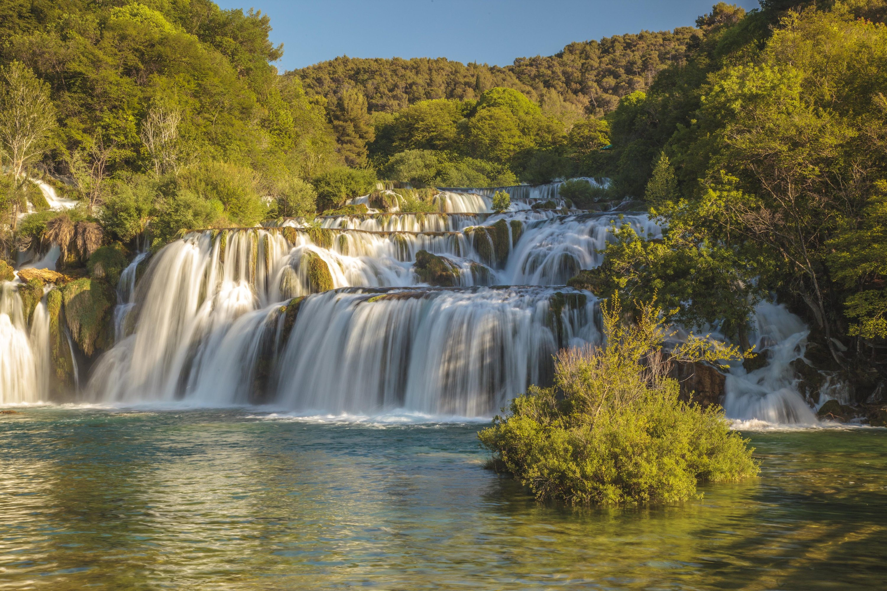 The Skradinski Buk waterfall, a flight of 17 travertine steps framed by willow and pine trees, is the most famous from Croatia