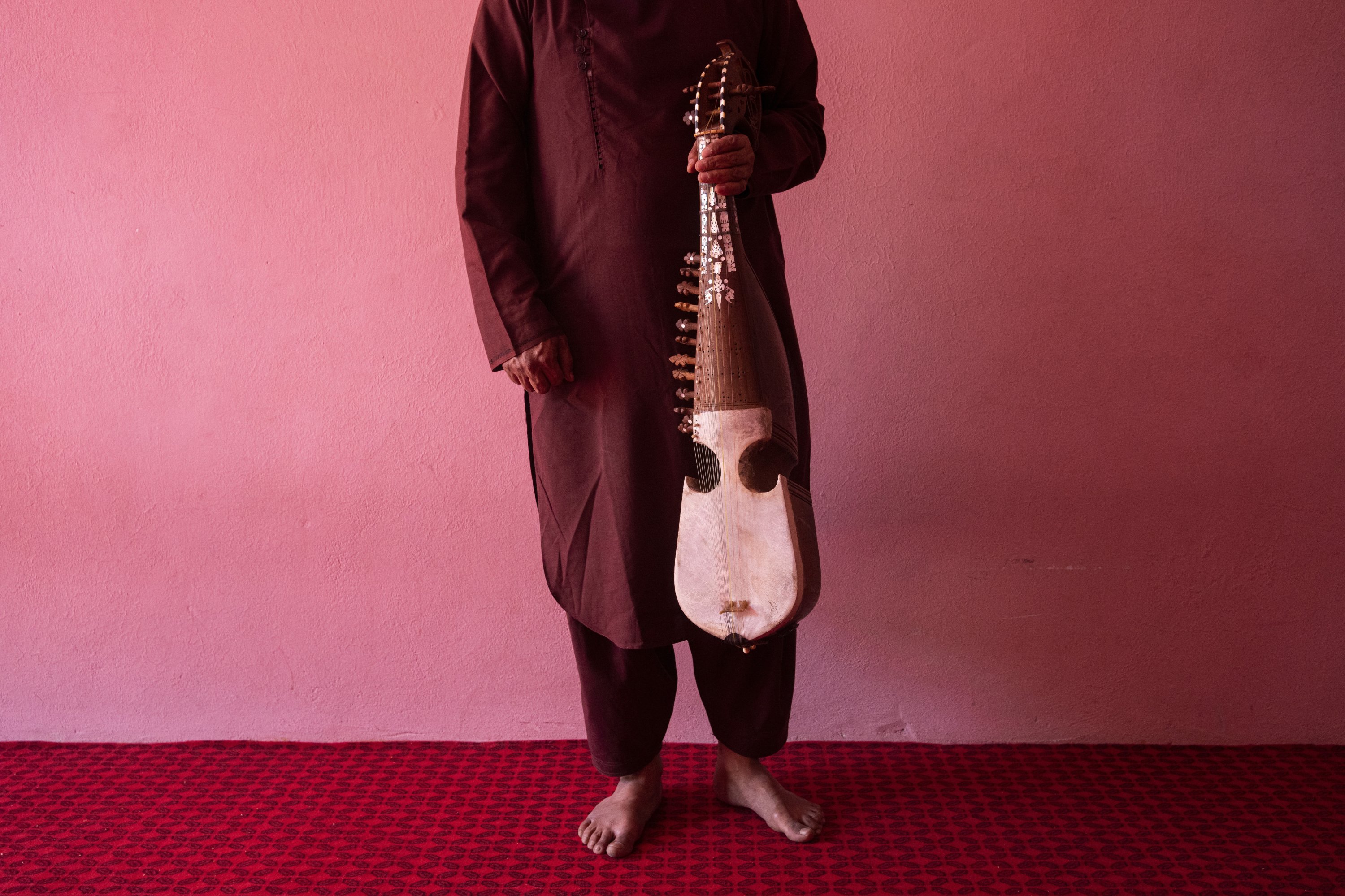 An Afghan musician poses for a portrait with his rubab in Kabul, Afghanistan, Thursday, Sept. 16, 2021. (AP)