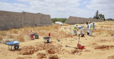 Libyan Ministry of Justice employees dig out at a site of a suspected mass grave in the town of Tarhuna, Libya, June 23, 2020. (AP File Photo)