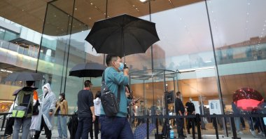 People wearing face masks are pictured at an Apple Store on the day the new Apple iPhone 13 series goes on sale, in Beijing, China, Sept. 24, 2021. (Reuters Photo)