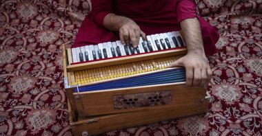 An Afghan musician plays the harmonium in Kabul, Afghanistan, Thursday, Sept. 16, 2021. (AP)