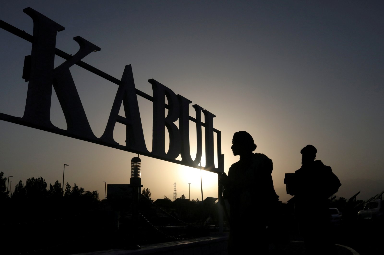 Taliban soldiers stand in front of a sign at Kabul Hamid Karzai International Airport  in Kabul, Afghanistan, Sept. 9, 2021. (REUTERS Photo)