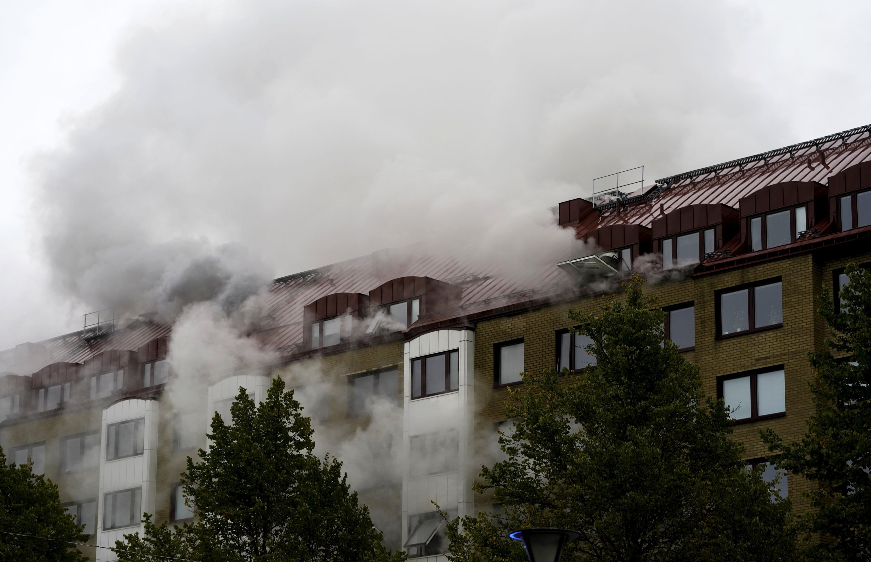 Smoke billows from an apartment building after an explosion in Annedal, central Gothenburg, Sweden, Sept. 28, 2021. (AP Photo)