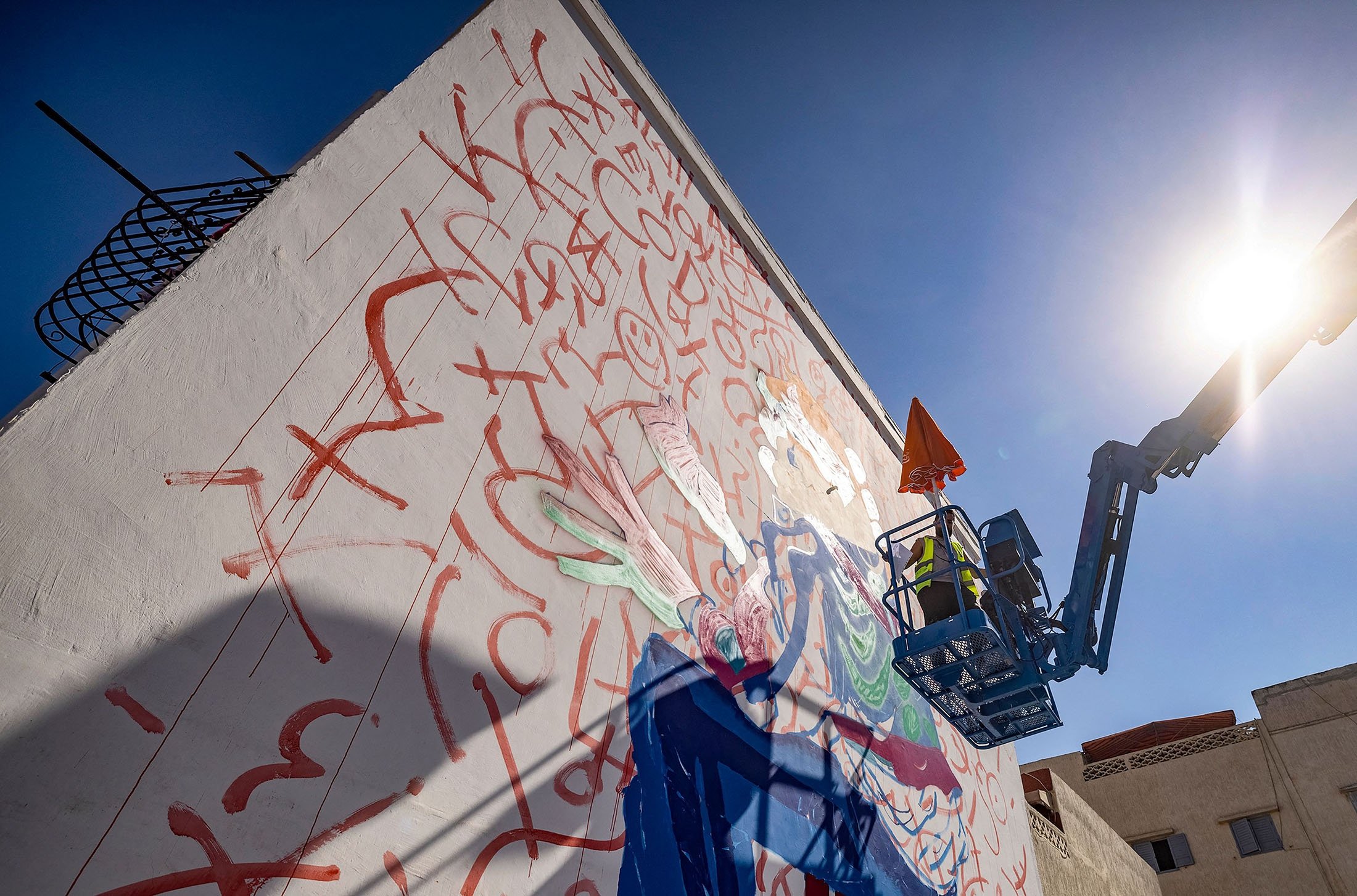 Moroccan street artist Omar Lhamzi works on a mural during the Jidar street art festival in the capital Rabat, Morocco, Sept. 20, 2021. (AFP Photo)