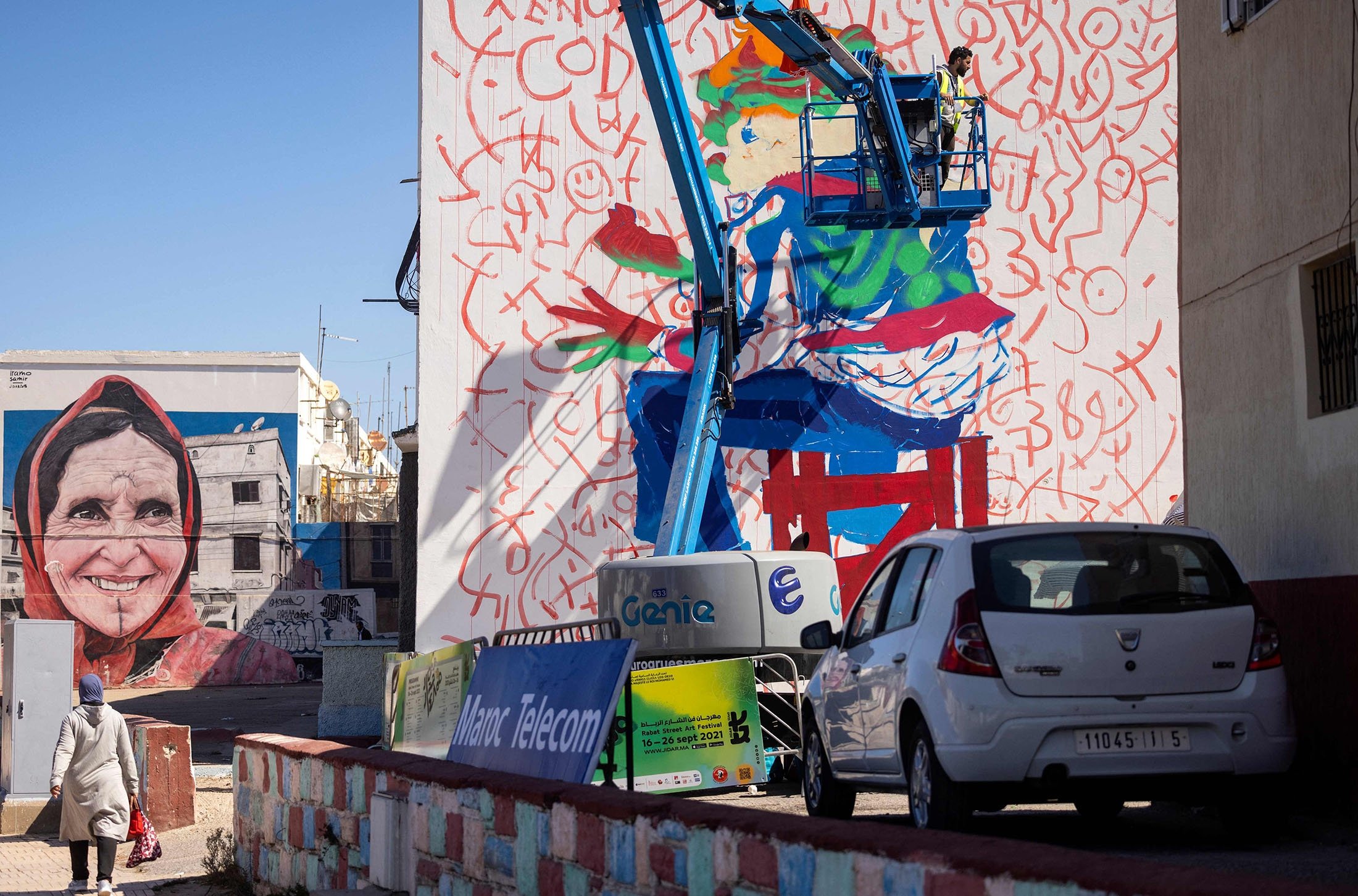 Moroccan street artist Omar Lhamzi works on a mural during the Jidar street art festival in the capital Rabat, Morocco, Sept. 20, 2021. (AFP Photo)