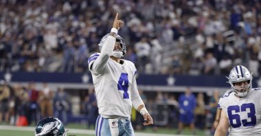 Dallas Cowboys quarterback Dak Prescott (4) and center Tyler Biadasz (63) celebrate a touchdown scored by Dalton Schultz in the second half of an NFL football game against the Philadelphia Eagles in Arlington, Texas, U.S., Monday, Sept. 27, 2021. (AP Photo)