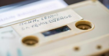 A cassette with the recording of four Danish schoolboys' interview with John Lennon and Yoko Ono is photographed at Bruun Rasmussen Auction House in Copenhagen, Denmark, Sept. 24, 2021. (AFP Photo)
