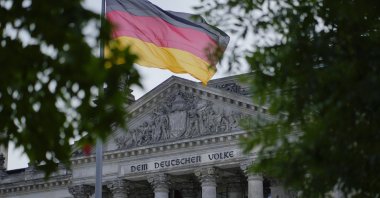 The German national flag waves in front of the German parliament building, the Reichstag Building, with the slogan "To The German People," in Berlin, Germany, Sept. 28, 2021. (AP Photo)