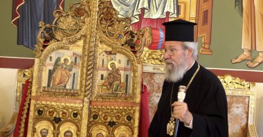 The leader of the Greek Cyprus Orthodox Church, Archbishop Chrysostomos II, stands next to a pair of ornate, gilded doors that guard the altar of a church, at the Archbishopric in the capital of the Greek Cypriot administration, Nicosia, Sept. 16, 2021. (AP Photo)