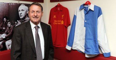 Roger Hunt poses with a replica 1892 blue and white quartered jersey and a brand new Liverpool kit at Anfield, Liverpool, England, June 1, 2012. (Getty Images)