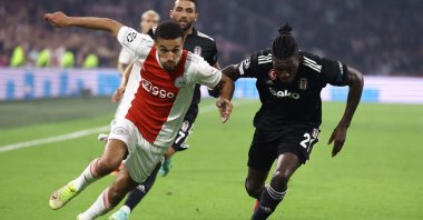Ajax's Noussair Mazraoui (L) fights for the ball with Besiktaş's Fabrice N'Sakala during a Champions League match at The Johan Cruijff Arena in Amsterdam, the Netherlands, Sept. 28, 2021. (AFP Photo)