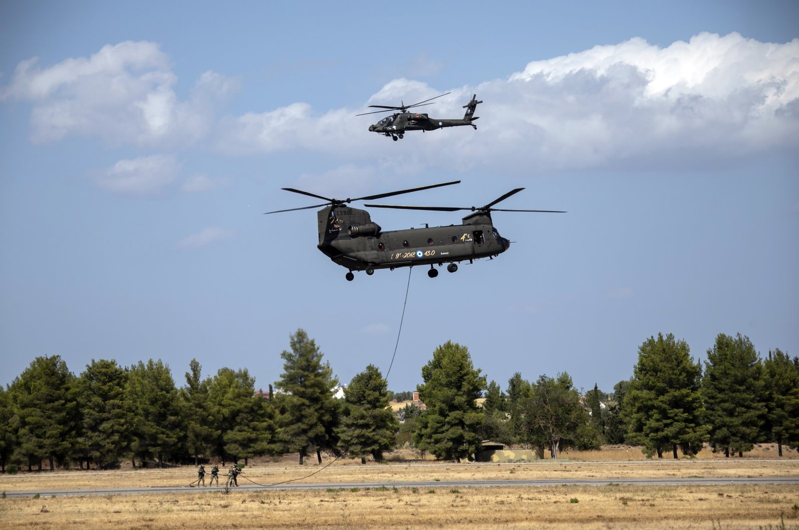 Greek military special forces perform with a CH-47 and a Kiowa helicopters during an airshow at Tanagra air base, north of Athens, Greece, Sept. 4, 2021. (AP Photo)