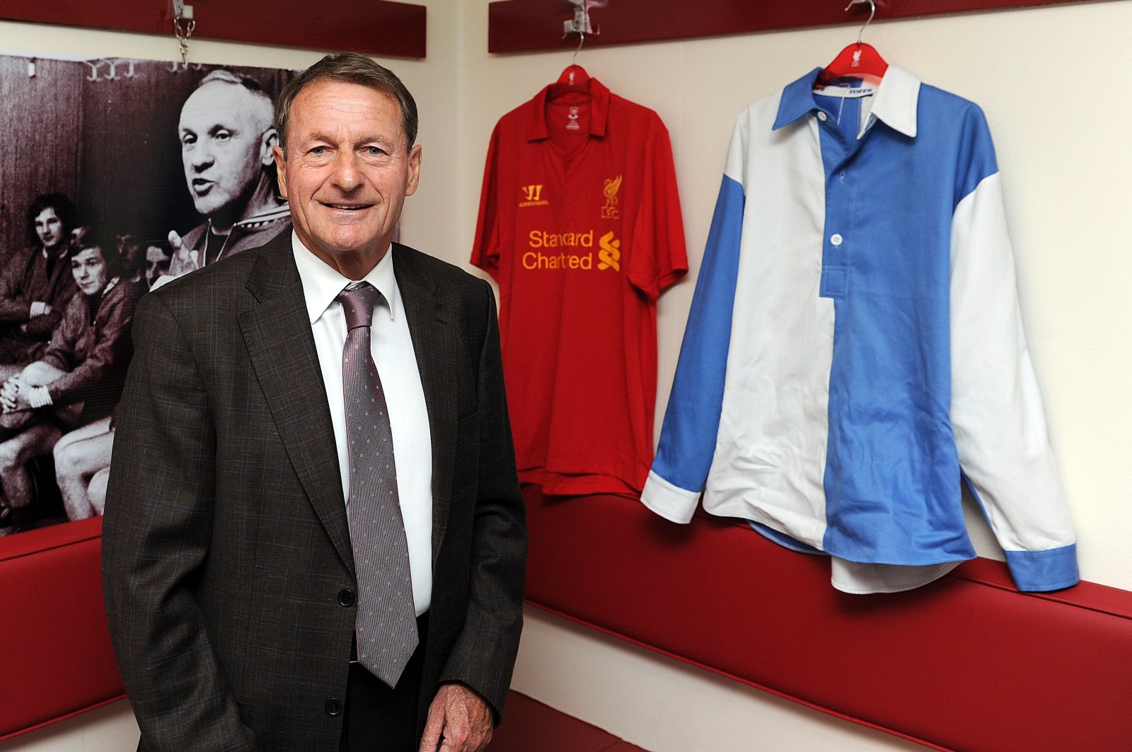 Roger Hunt poses with a replica 1892 blue and white quartered jersey and a brand new Liverpool kit at Anfield, Liverpool, England, June 1, 2012. (Getty Images)