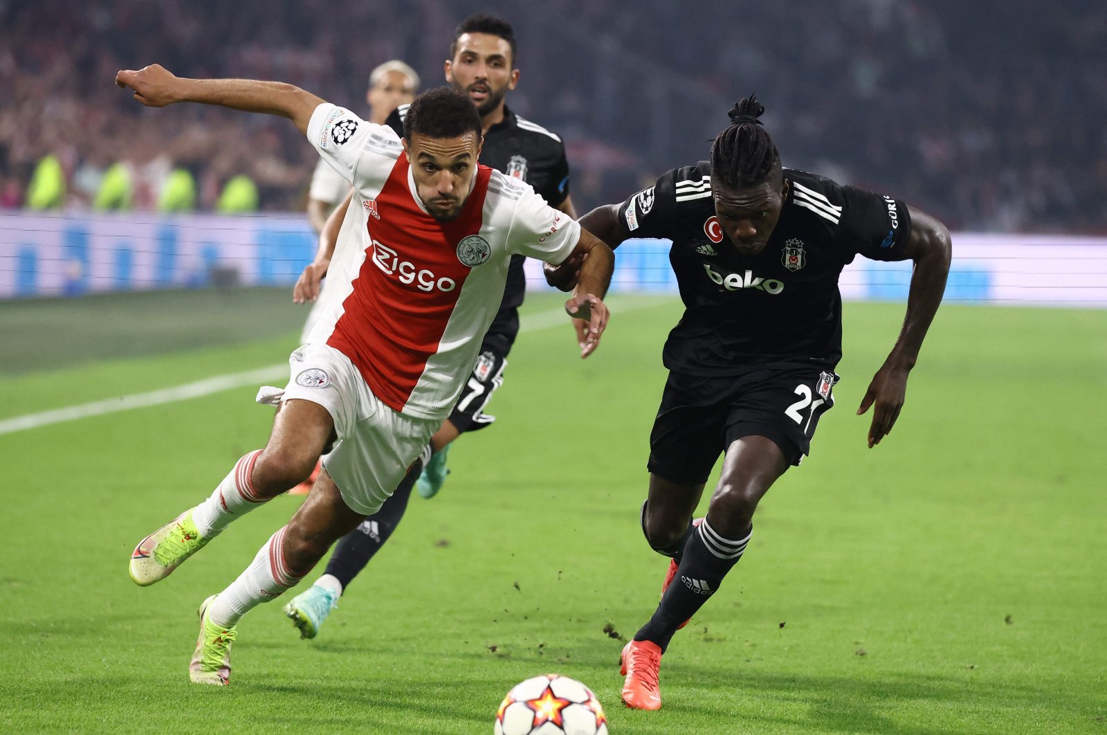 Ajax's Noussair Mazraoui (L) fights for the ball with Besiktaş's Fabrice N'Sakala during a Champions League match at The Johan Cruijff Arena in Amsterdam, the Netherlands, Sept. 28, 2021. (AFP Photo)