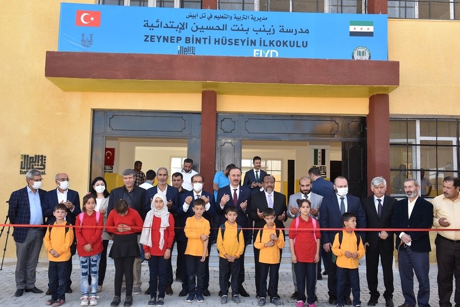 Officials and students attend the opening ceremony of Zeynep Binti Hüseyin Primary School in Tal Abyad, northern Syria, Sept. 28, 2021. (AA Photo)