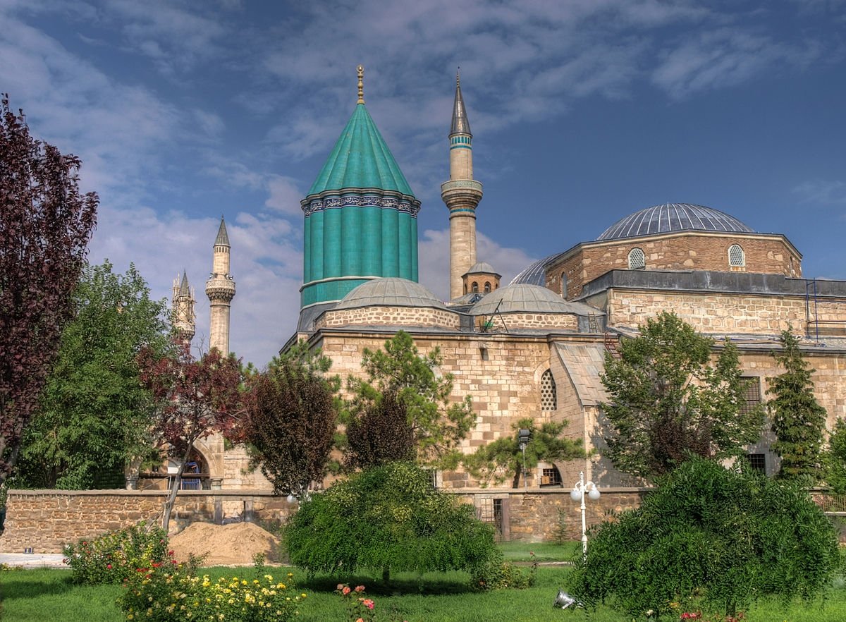 The shrine of Rumi in central Konya province comes to the forefront with its distinctive green-tiled cylindrical dome.
