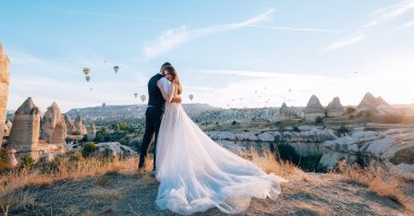 A young married couple posing for a photo in Cappadocia, Turkey. (Shutterstock Photo)