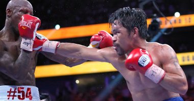Manny Pacquiao (R) fights Yordenis Ugasin a world welterweight championship bout at T-Mobile Arena, Las Vegas, Nevada, U.S., Aug. 21, 2021.  (USA TODAY Sports Photo via AP)