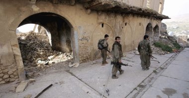 PKK terrorists walk in the damaged streets of Sinjar, Iraq, Jan. 29, 2015.  (AP File Photo)