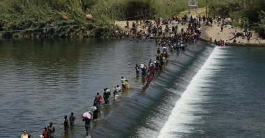 Haitian migrants use a dam to cross into the United States from Mexico in Del Rio, Texas, U.S., Sept. 18, 2021. (AP Photo)