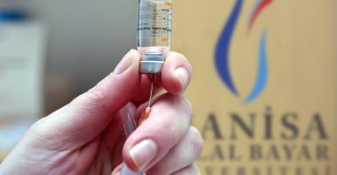 A healtcare worker draws a dose of Sinovac's COVID-19 vaccine into syringe at the Hafsa Sultan Hospital of Manisa Celal Bayar University, in Manisa, Turkey, Sept. 28, 2021. (AA Photo)