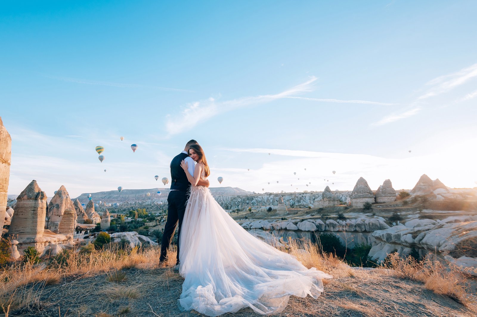 A young married couple posing for a photo in Cappadocia, Turkey. (Shutterstock Photo)