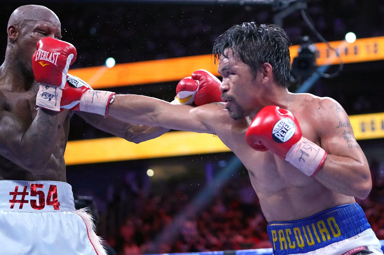 Manny Pacquiao (R) fights Yordenis Ugasin a world welterweight championship bout at T-Mobile Arena, Las Vegas, Nevada, U.S., Aug. 21, 2021.  (USA TODAY Sports Photo via AP)